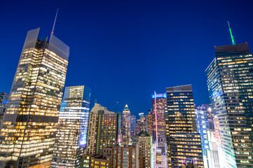 Aerial View of Manhattan Skyscrapers Illuminated at Night with Vibrant City Lights