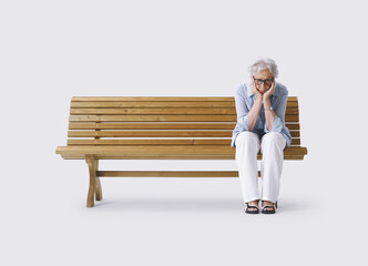 Elderly Woman Alone and Sad Sitting on a Bench, Holding Her Head in Her Hands. Concept of...