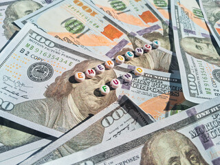 Concept image of emergency fund with dollar bills and colorful alphabet beads