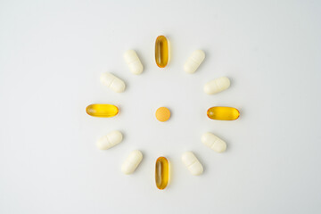 Clock made of pills capsules, pills form a circle, omega, vitamins, Cod liver oil, supplements