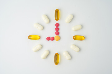 Clock made of pills capsules, pills form a circle, omega, vitamins, Cod liver oil, supplements
