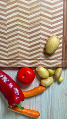 Rustic vegetables beckon harvest fairytales: red pepper, vibrant tomato, curious potatoes, and...