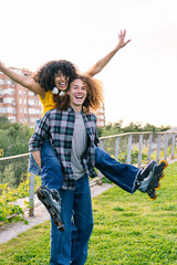 Young man giving a joyful piggyback ride to his girlfriend while skating together in a vibrant...