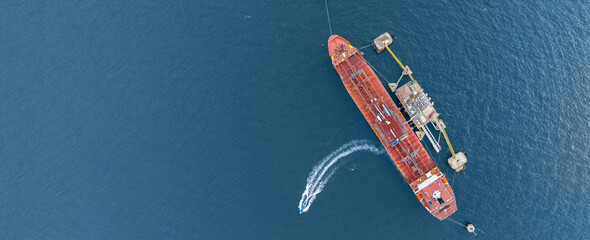 Aerial view oil ship tanker vessel loading and unloading in oil terminal station refinery, Global...