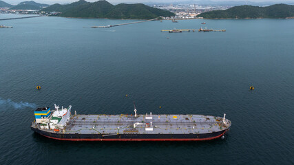 Aerial view oil ship tanker vessel loading and unloading in oil terminal station refinery, Global...