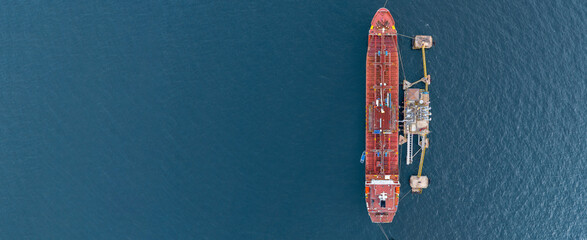 Aerial view oil ship tanker vessel loading and unloading in oil terminal station refinery, Global...