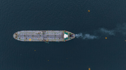 Aerial view oil ship tanker vessel loading and unloading in oil terminal station refinery, Global...