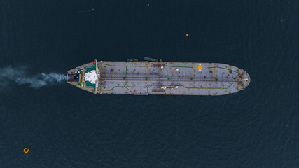 Aerial view oil ship tanker vessel loading and unloading in oil terminal station refinery, Global...