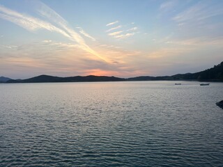 A peaceful sunrise over the calm sea at Seosan, Korea, with warm orange and pink colors reflecting on the water. Perfect for travel blogs, nature backgrounds, and inspirational content.