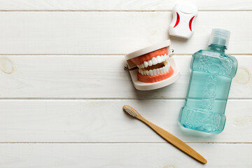 Mouthwash and other oral hygiene products on colored table top view with copy space. Flat lay. Dental hygiene. Oral care kit. Dentist concept