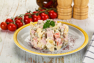 Russian traditional Olivier salad with sausages
