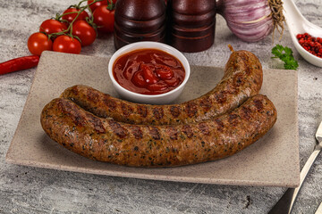 Grilled beef sausages with sauce