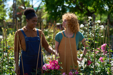 Gardeners taking care of roses in a plant nursery