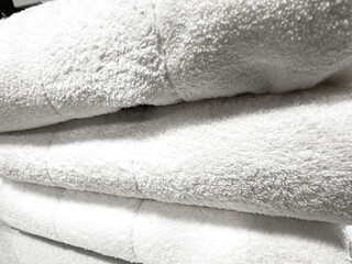 Clean White Fluffy Bath Towels Stacked Neatly