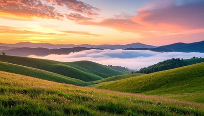 Fototapeta premium A breathtaking view of rolling green hills at sunrise, shrouded in mist with vibrant colors illuminating the sky.