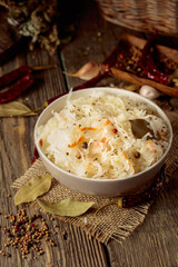 Traditional German sauerkraut on a old rustic wooden table.
