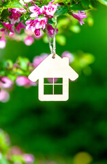  The symbol of the house among the branches of the pink weigela
