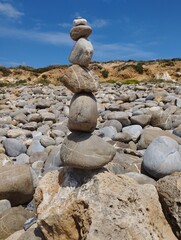 Stacked natural stones on a rocky beach in Portugal