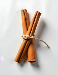 Cinnamon sticks wrapped with a rustic thread isolated on the white background
