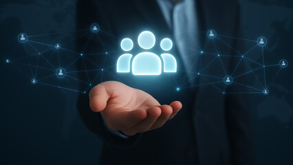Business hand holding glowing team icon connected to network grid representing virtual collaboration, user integration and smart social connection system on global platform