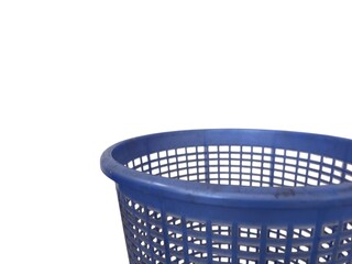 A close-up of the rim and perforated texture of a blue plastic laundry basket or storage bin,...