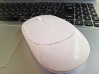 Computer mouse with blurred keyboard in the background