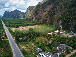 Aerial view of the asphalt road along the tropical forest in countryside