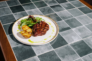 Grilled steak with vegetables on a decorative table in a modern restaurant