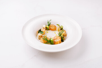 Seared scallops with herbs, served elegantly in a bowl