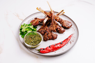 Delicious grilled lamb chops served with herb sauce and chili