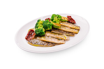 Delicious seared fish with steamed broccoli and sun-dried tomatoes on a plate