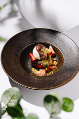 Decadent dessert featuring strawberries and chocolate served in elegant dish