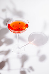 Cocktail with cherries displayed elegantly on a clean surface