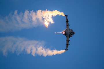 Fighter jet firing off flares