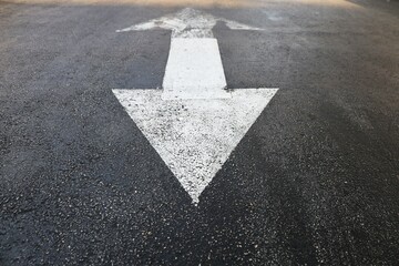 Two sides triangle arrow sign on the road asphalt