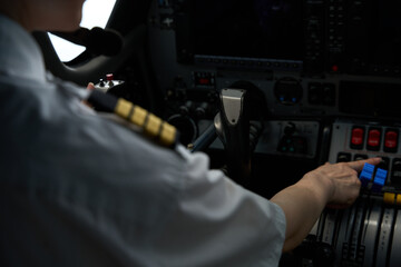 Pilot operating aircraft controls inside cockpit during flight training