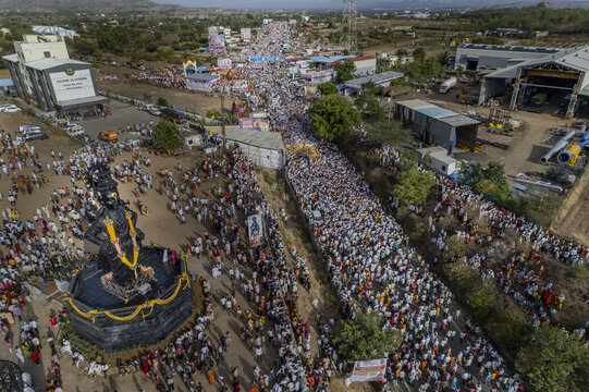 Aerial view of a large gathering of people along a street as they participate in Pandharpur Wari in Maharashtra, India.