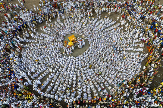 Aerial view of a large gathering of people along a street as they participate in Pandharpur Wari in Maharashtra, India.