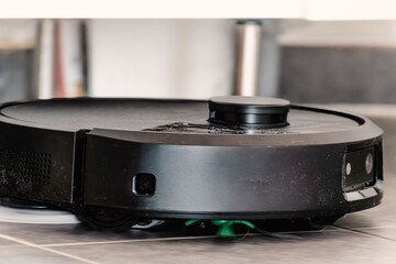 Robot vacuum cleaner with dust, real life photo, saves time and goes into hard-to-reach places