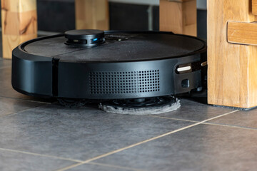 Robot vacuum cleaner with dust, real life photo, saves time and goes into hard-to-reach places