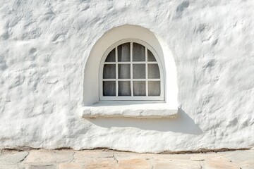 small arch window in white textured wall.