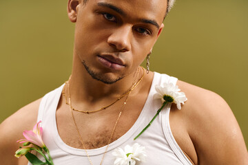 Trendy young man with dyed hair showcases floral style in studio setting