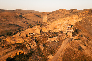 Aerial view Natlismtsemeli Monastery complex carved into cliffs, medieval Georgian Orthodox...