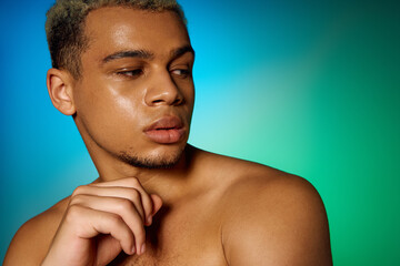 Muscular young man posing with dyed hair in a vibrant studio setting