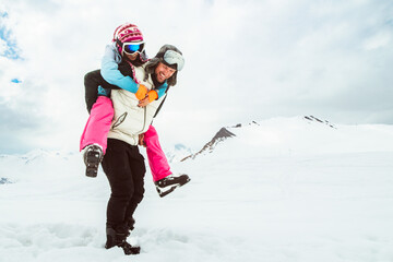 background of laughing couple enjoy romantic piggyback ride in snowy winter landscape, expressing...