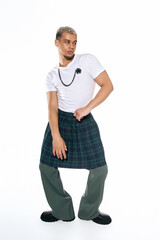 Stylish young Black man in studio showcasing modern fashion trends and colored hair