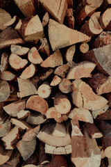 Stacked firewood background with textured logs. Cut firewood front view.