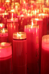 Giant red candles glow brightly in a temple during Chinese New Year and Cap Go Meh celebrations, symbolizing hope and prosperity.