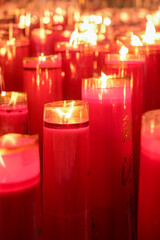 Giant red candles glow brightly in a temple during Chinese New Year and Cap Go Meh celebrations, symbolizing hope and prosperity.