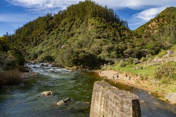 Hikers enjoy the Karangahake Gorge, a popular scenic reserve in New Zealand. The Ohinemuri River...